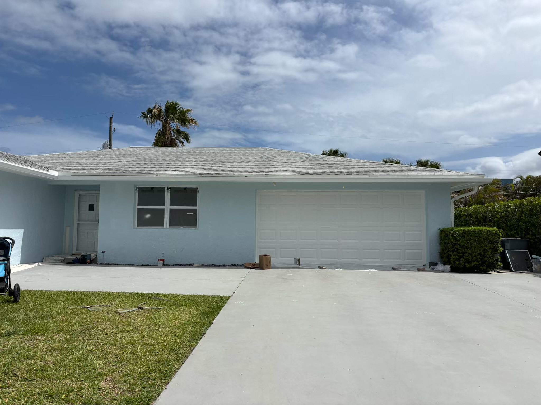 Wide front view of a freshly painted blue home