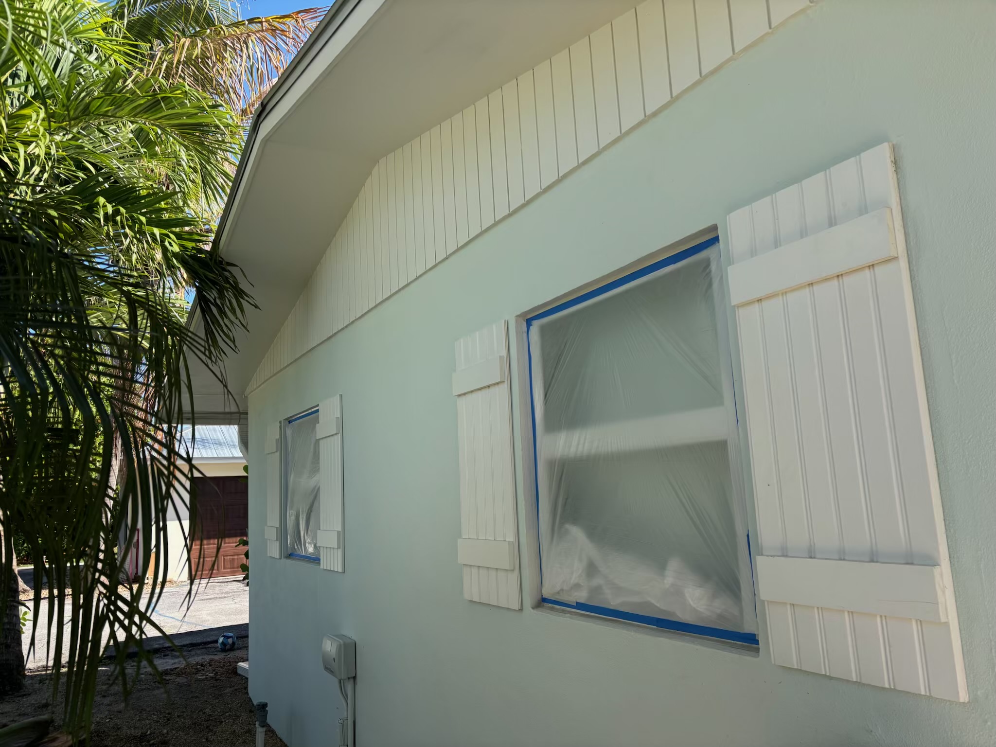 Exterior shutters and trim detail on a painted home