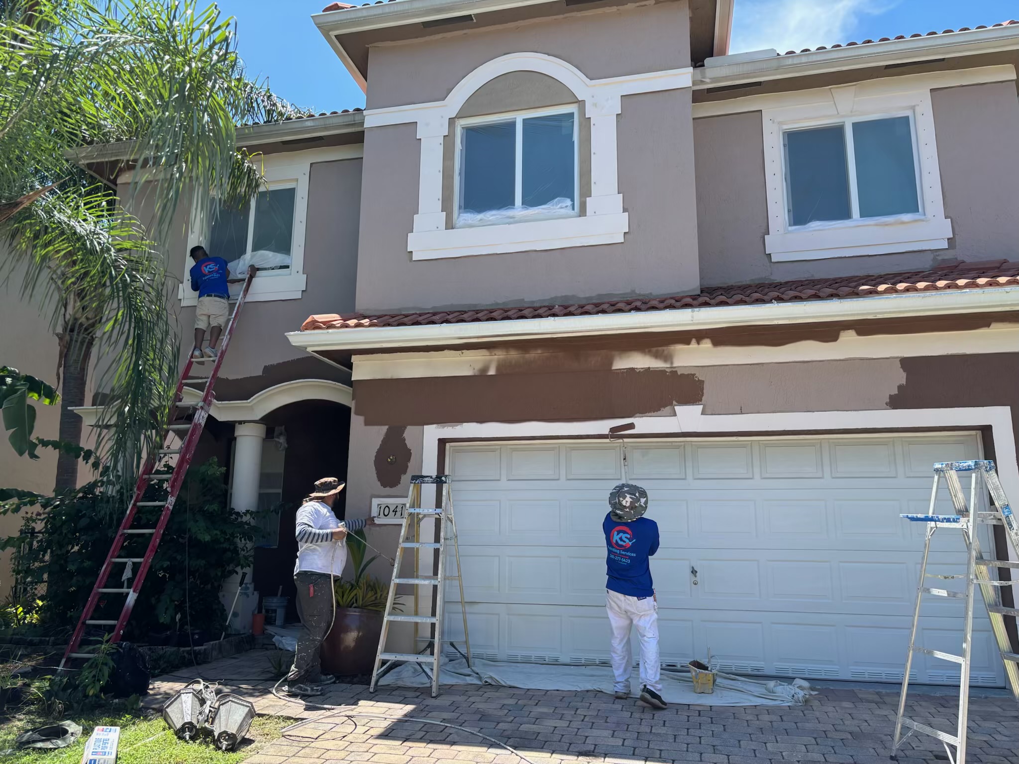 Two-story exterior painting project in progress