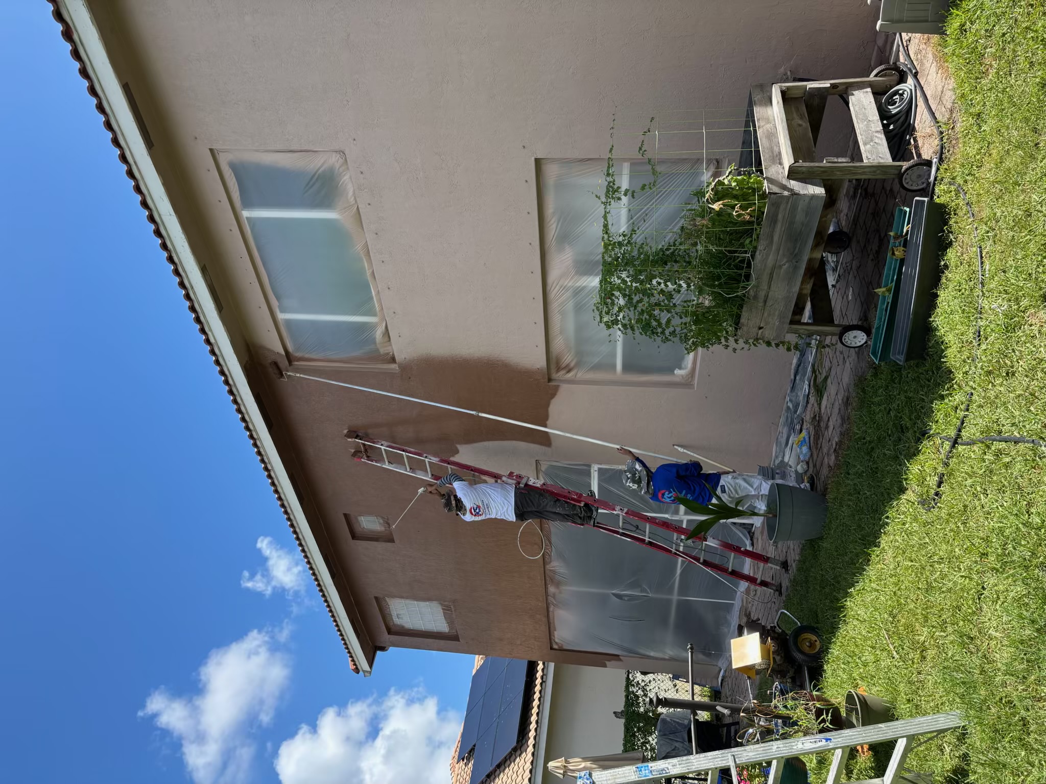 Rear view of a two-story exterior painting project