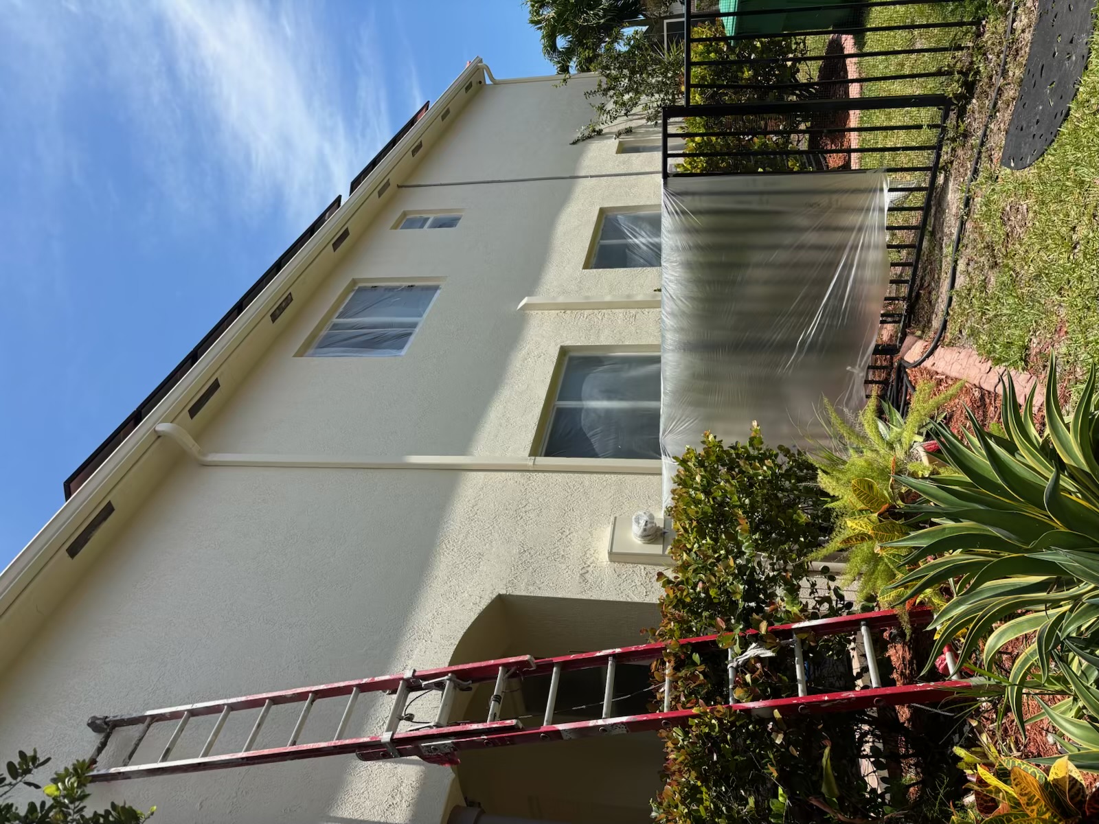 Finished side view of a two-story exterior repaint