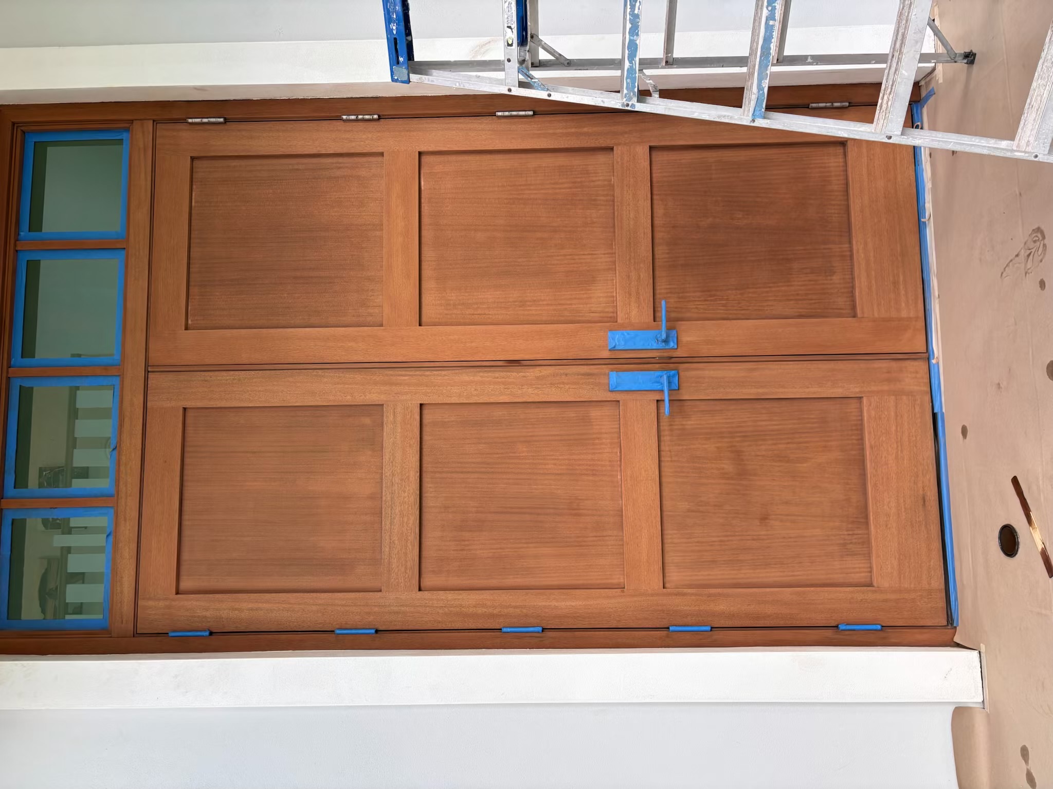 Rich wood front door finish completed by KS Painting Palm Beach LLC