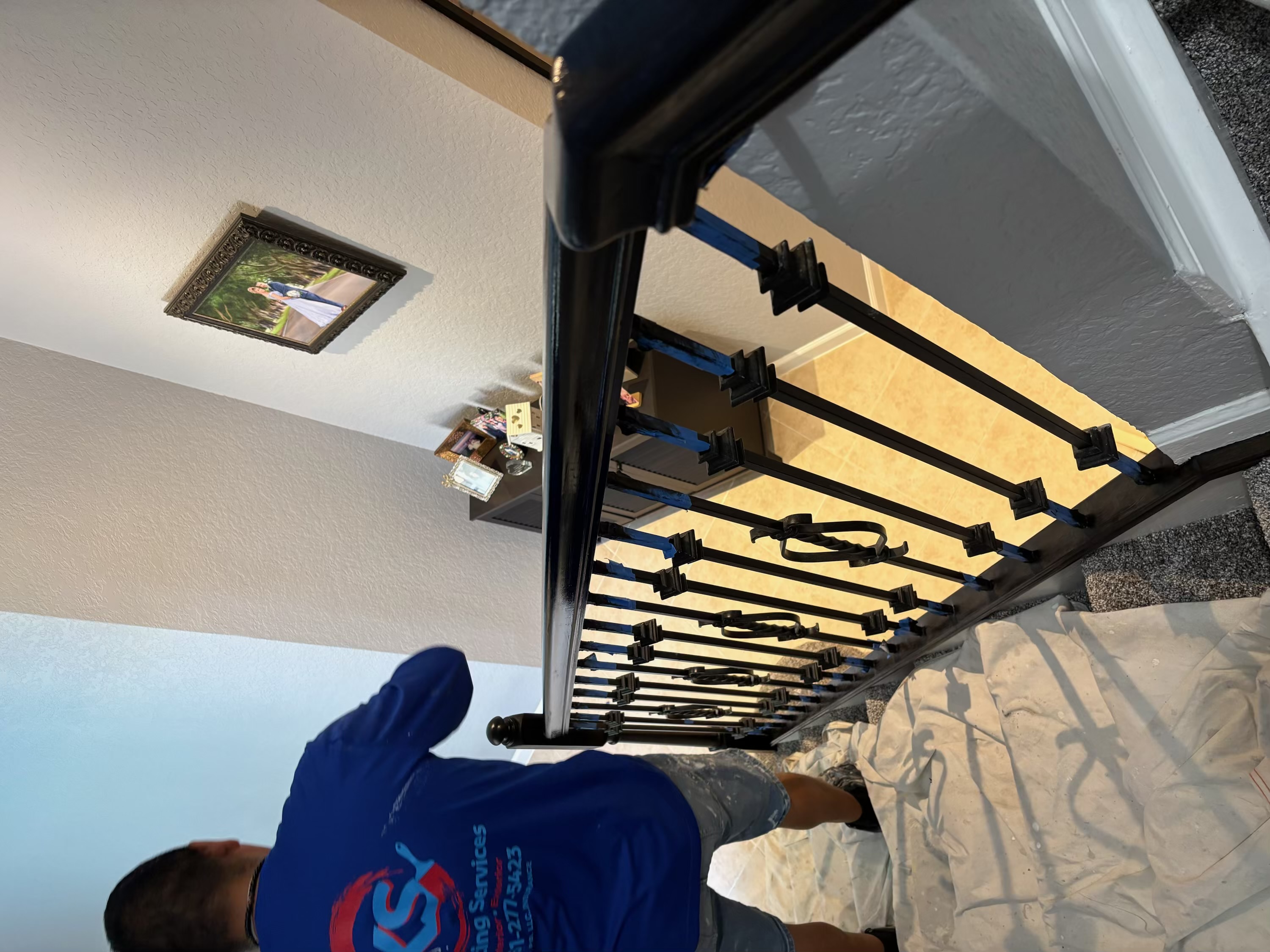 Closeup of stair railing refinishing work